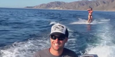 Dolphins join to the woman who was waterboarding. Dolphins join to the woman who was waterboarding.
