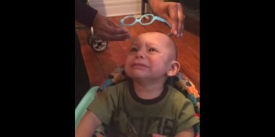 A child born with vision impaired is so happy after he wears glasses and sees the world better. A child born with vision impaired is so happy after he wears glasses and sees the world better.
