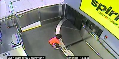 Toddler takes a ride on a conveyer belt at the airport until he is rescued by employees. Toddler takes a ride on a conveyer belt at the airport until he is rescued by employees.