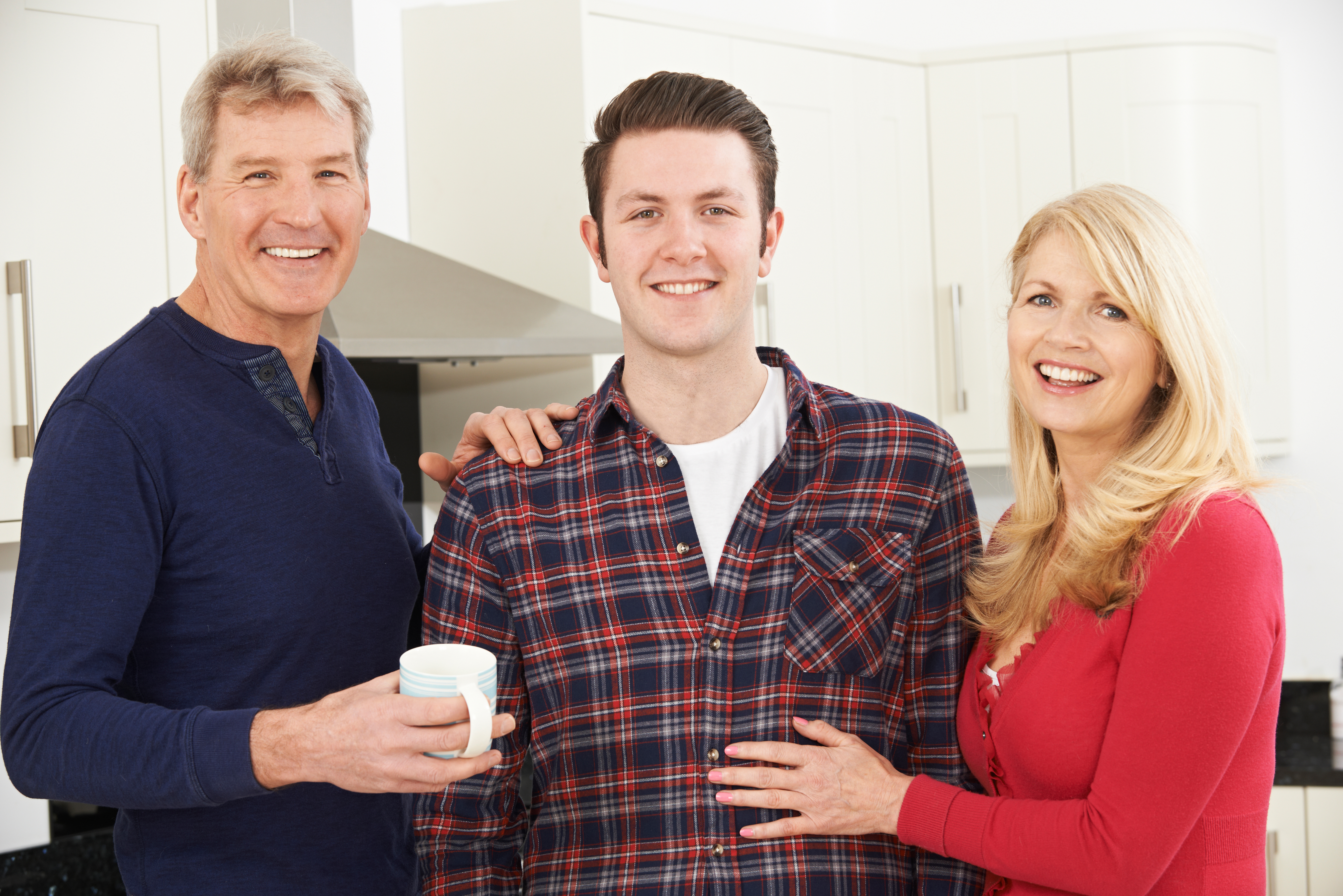 A family photographed smiling | Source: Shutterstock