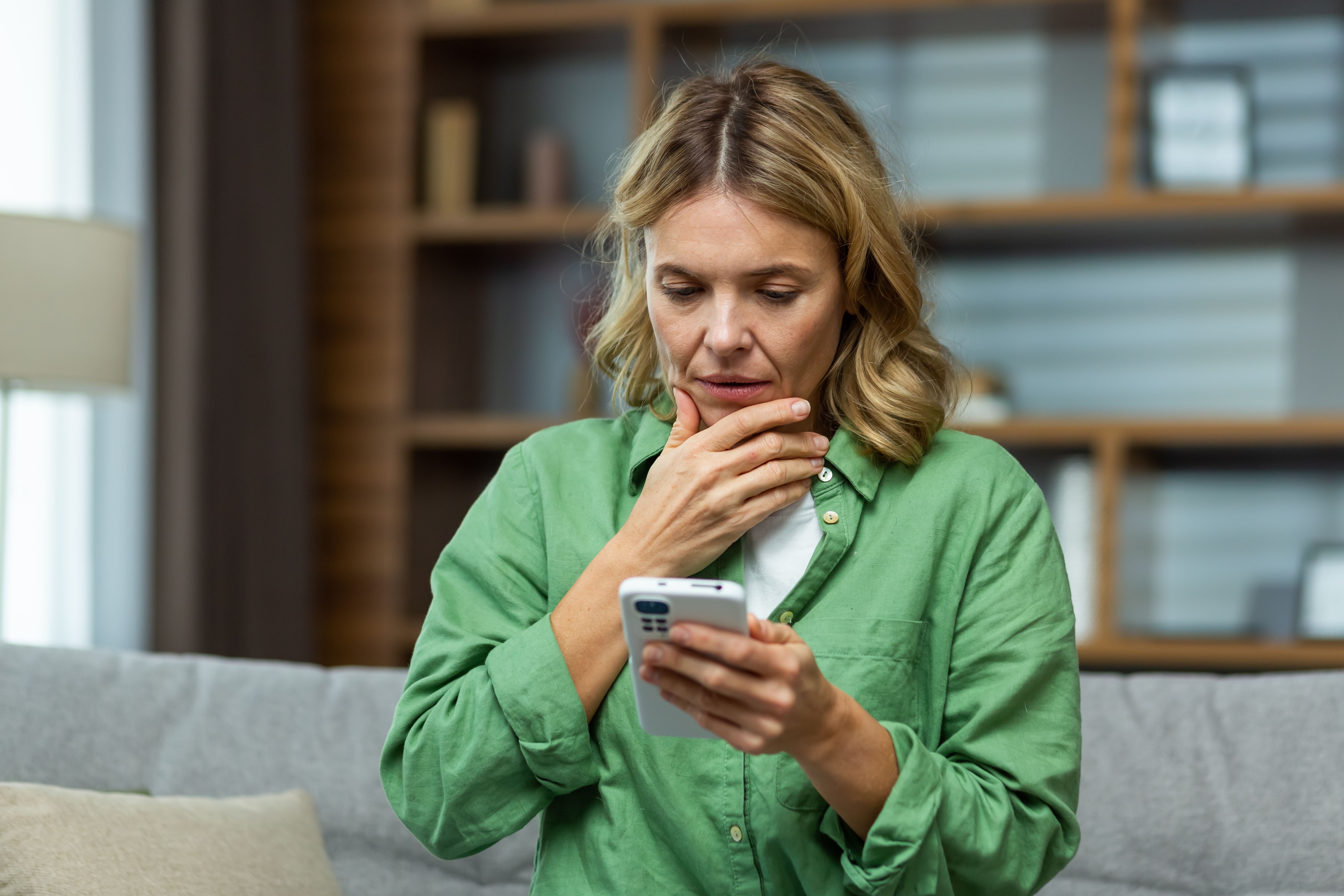 A worried senior woman holding her phone | Source: Shutterstock
