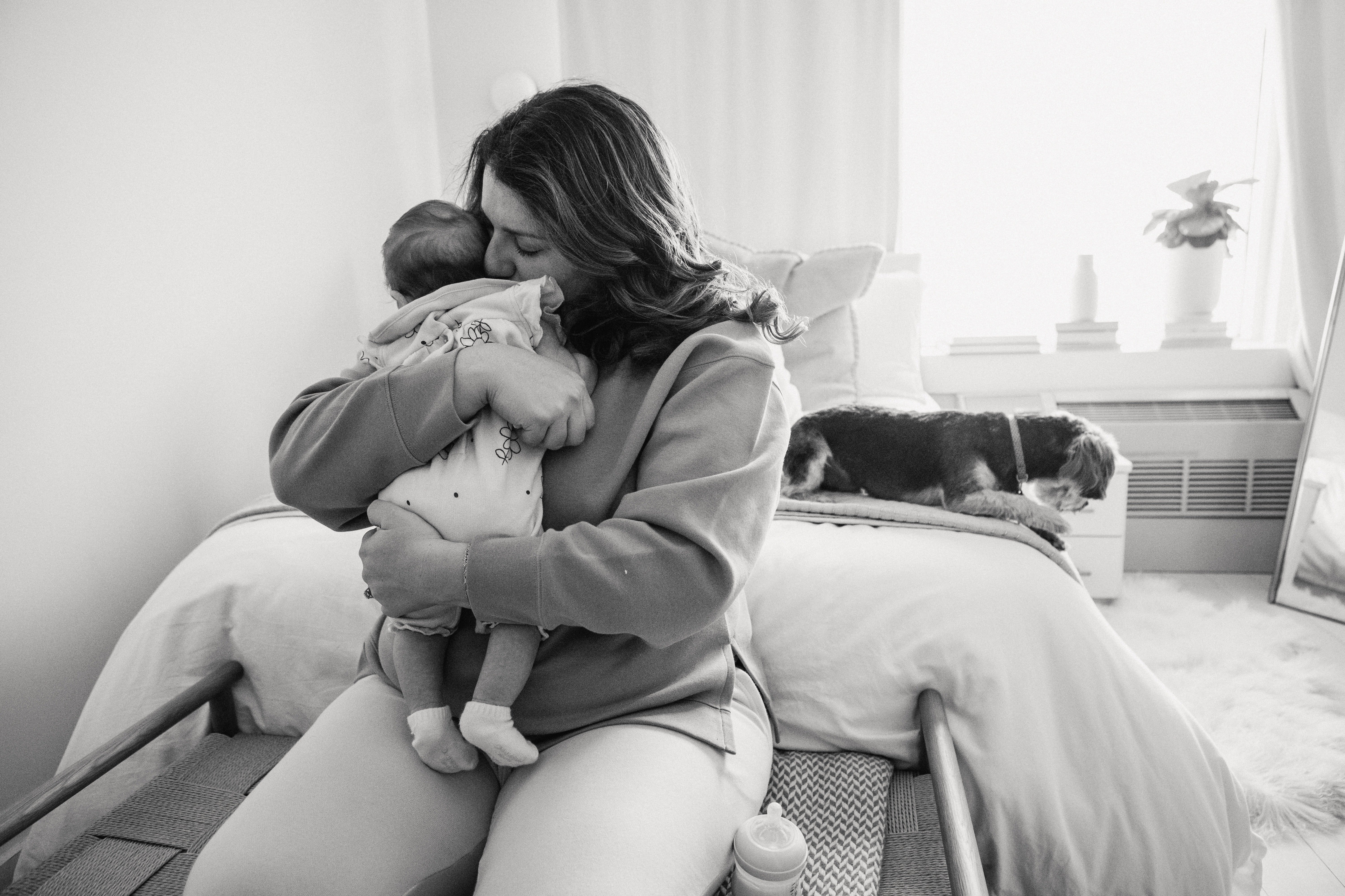 A woman cuddling a baby. | Source: Pexels