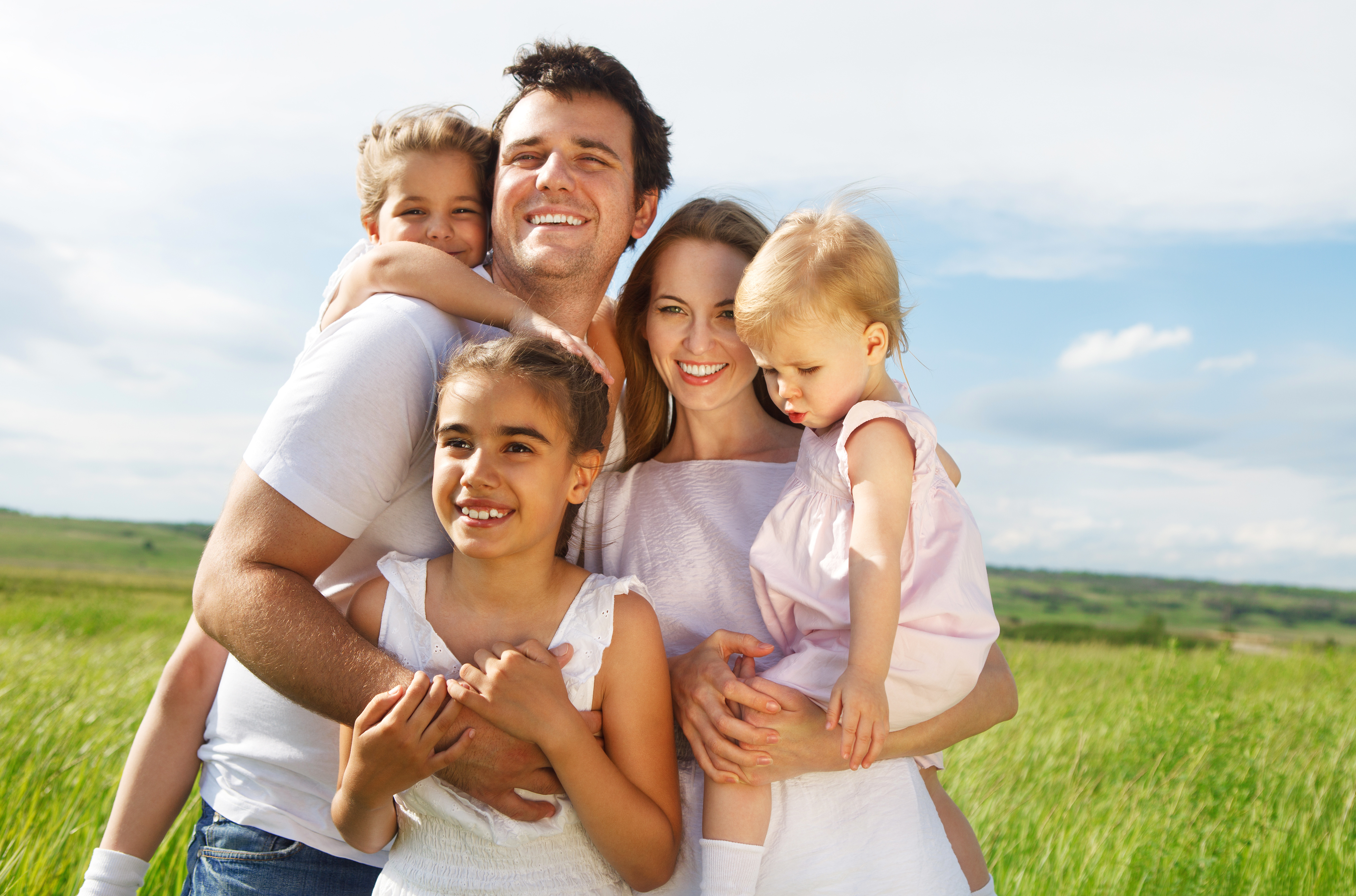 A happy couple with their three kids | Source: Shutterstock