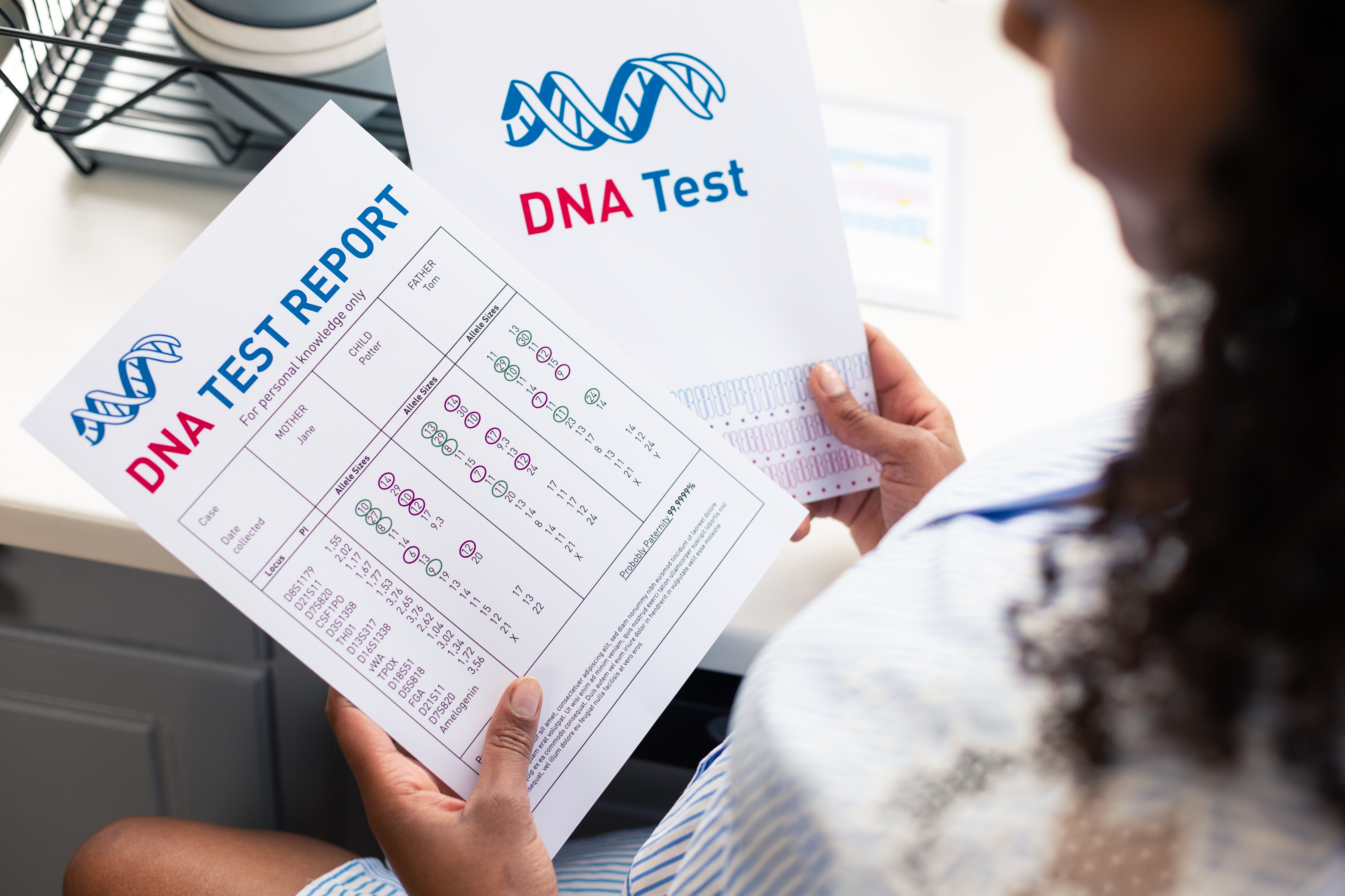 A woman holding and looking at a DNA test. | Source: Shutterstock