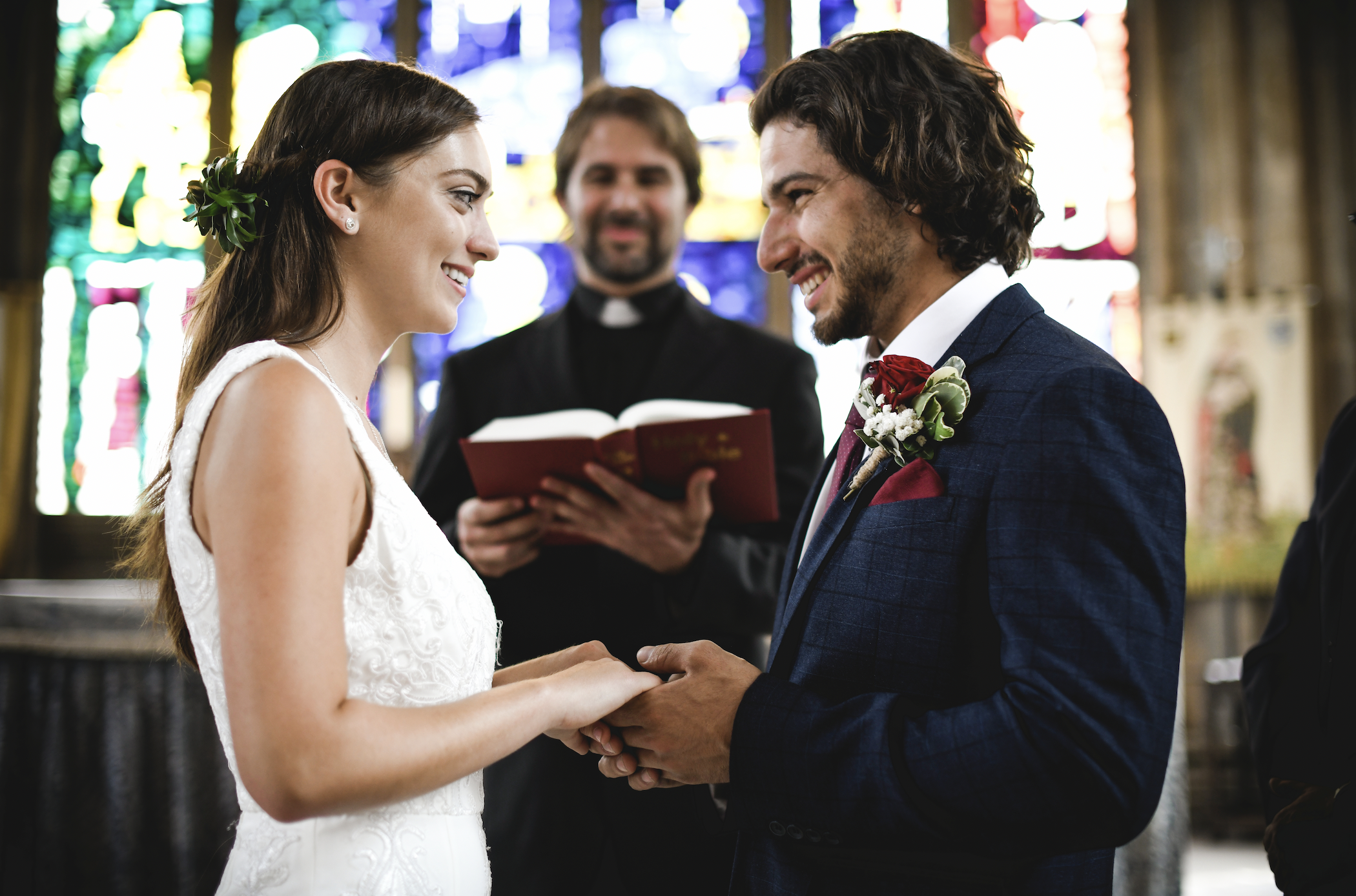 A bride and a groom are at the altar | Source: Shutterstock