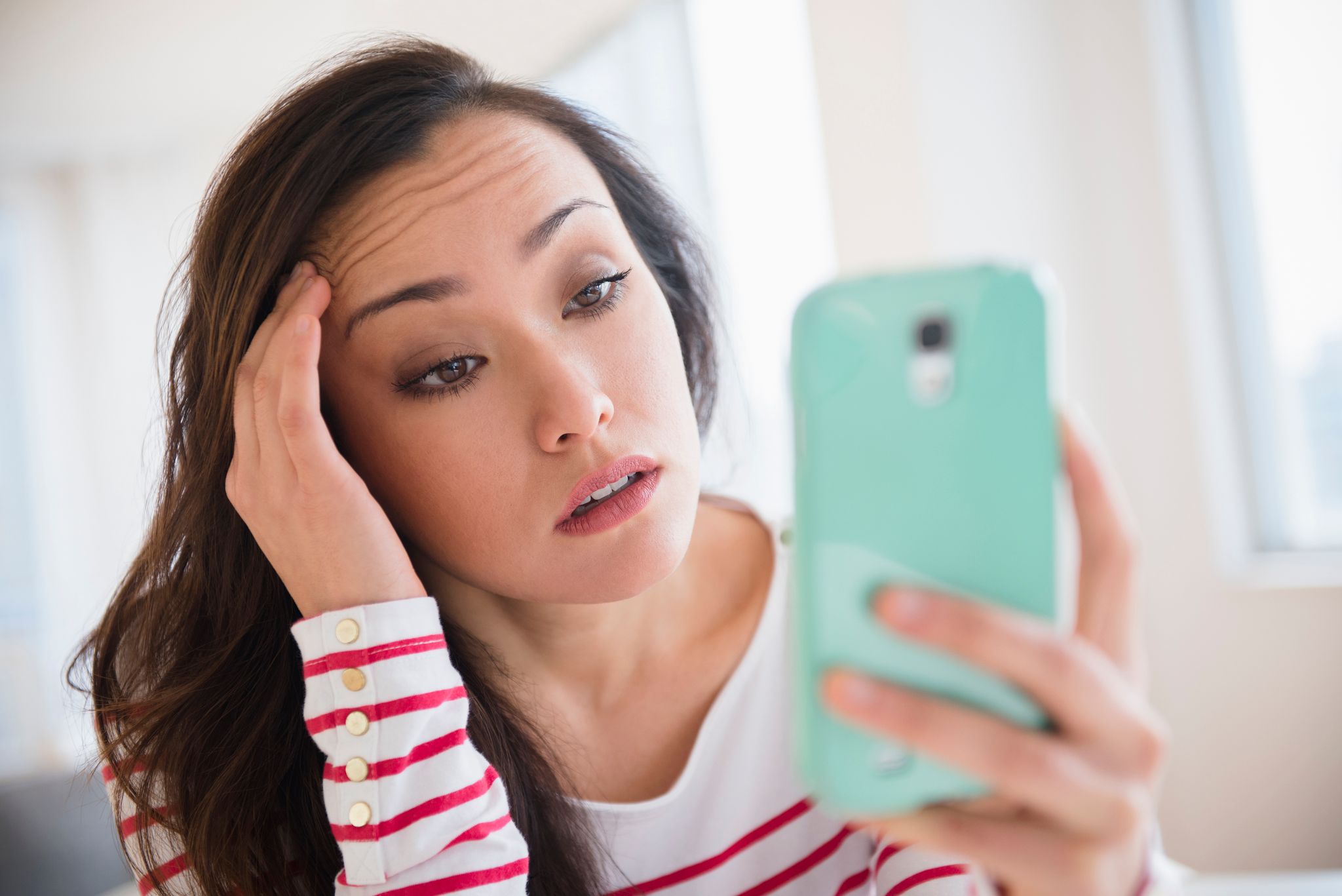 A woman looking at her phone. | Source: Getty Images